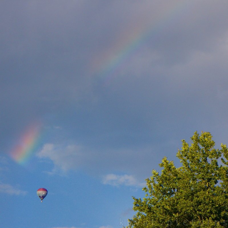 A hot air balloon and a rainbow